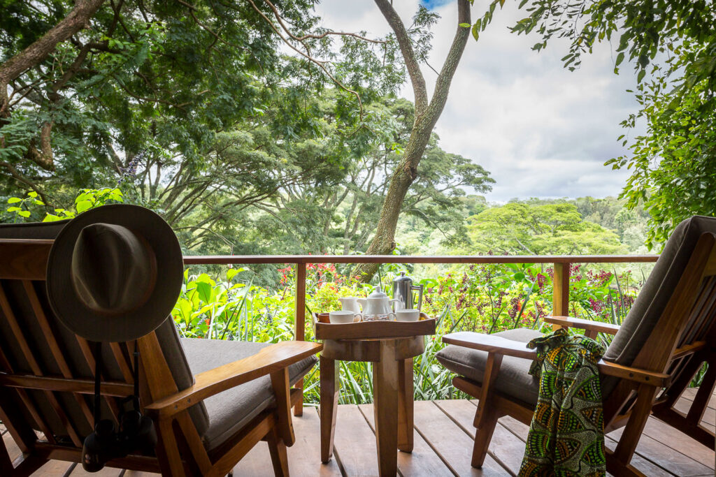 Lush gardens and historic farmhouse building at Gibb's Farm, Tanzania