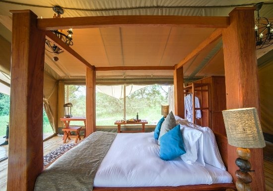 Spacious and modern interior of a guest tent at Asanja Grumeti