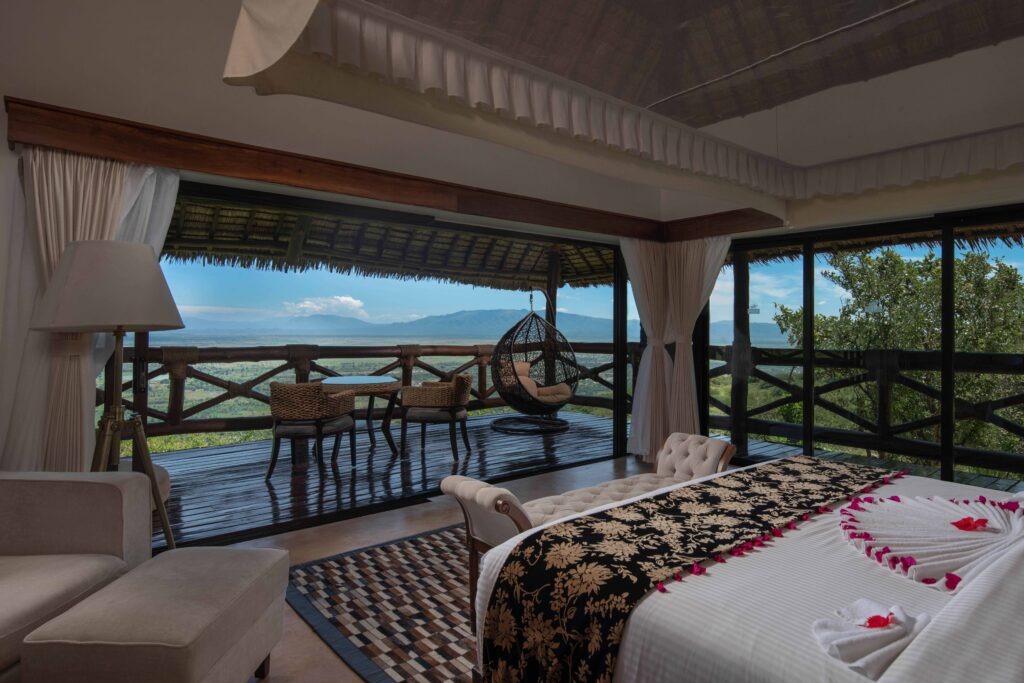 Luxurious suite interior with private balcony at Lake Manyara Kilimamoja Lodge