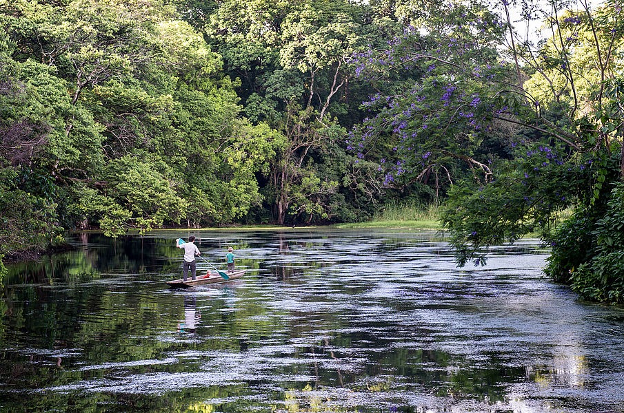 Relaxing by the clear waters or in the lush gardens of the lodge