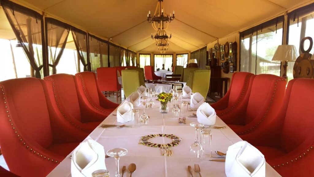 Spacious and elegant interior of a safari tent at Ole Serai Camp Kogatende