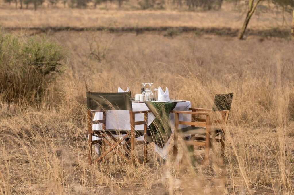 Dining tent setup at Ole Serai Camp Kogatende offering a bush dining experience