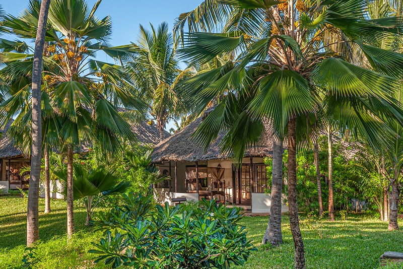 Couple enjoying a romantic private beach dinner at The Palms Zanzibar