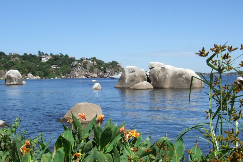 The iconic Bismarck Rock formation in Lake Victoria, Mwanza, with fishing boats nearby.