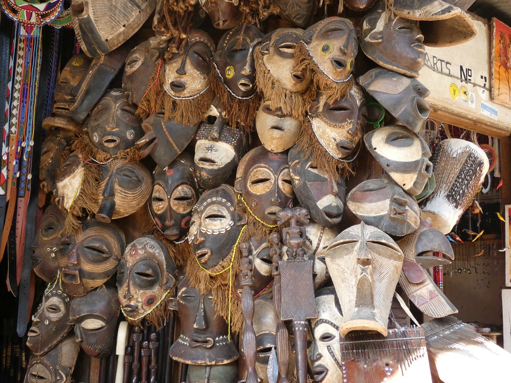 Colorful display of Tanzanian crafts and souvenirs at a market stall.